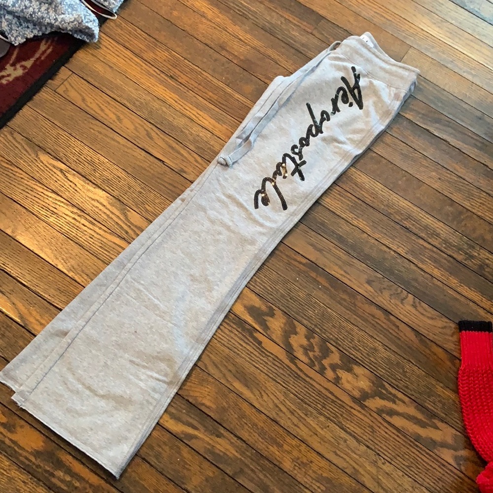 Gray sweatpants with black glitter lettering